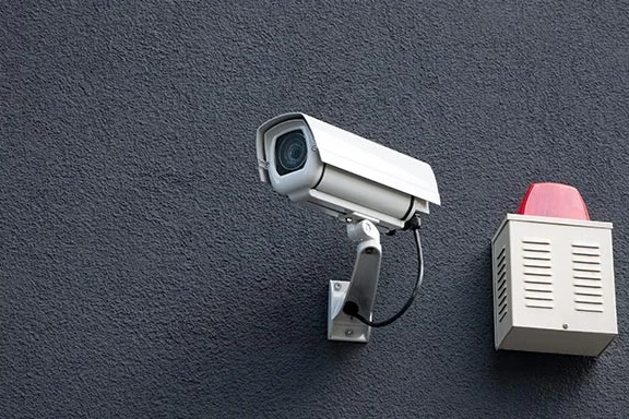 Überwachungskamera und Alarmsirene an Wand