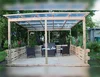 Gartenlaube aus Holz mit Wellblechdach
