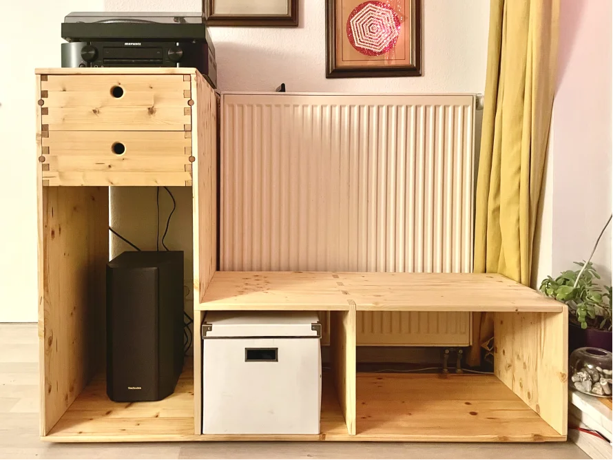 Ein selbstgebautes HiFi-Regal aus hellem Holz.